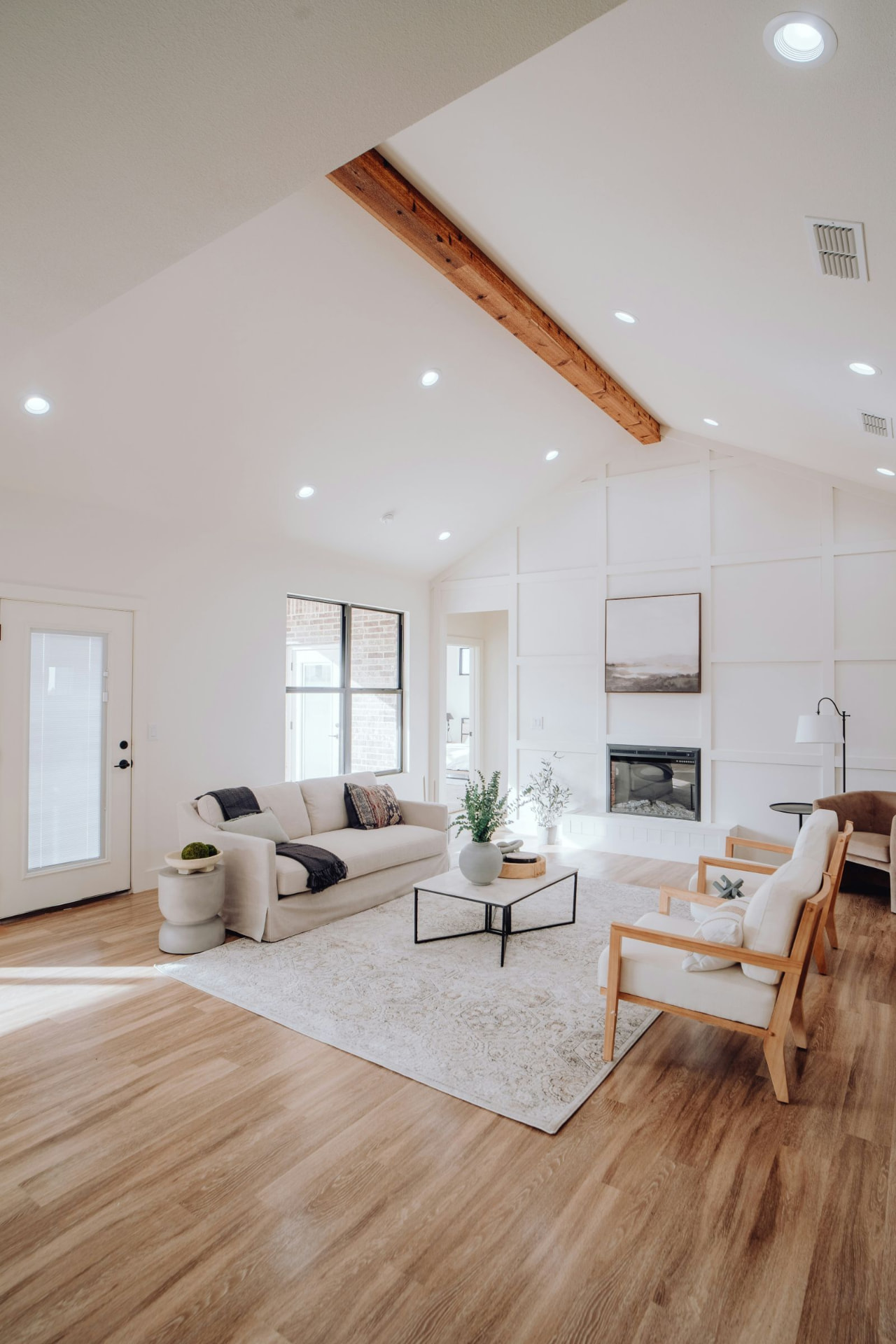 Bright living room with white sofa and timber beam in soft morning light